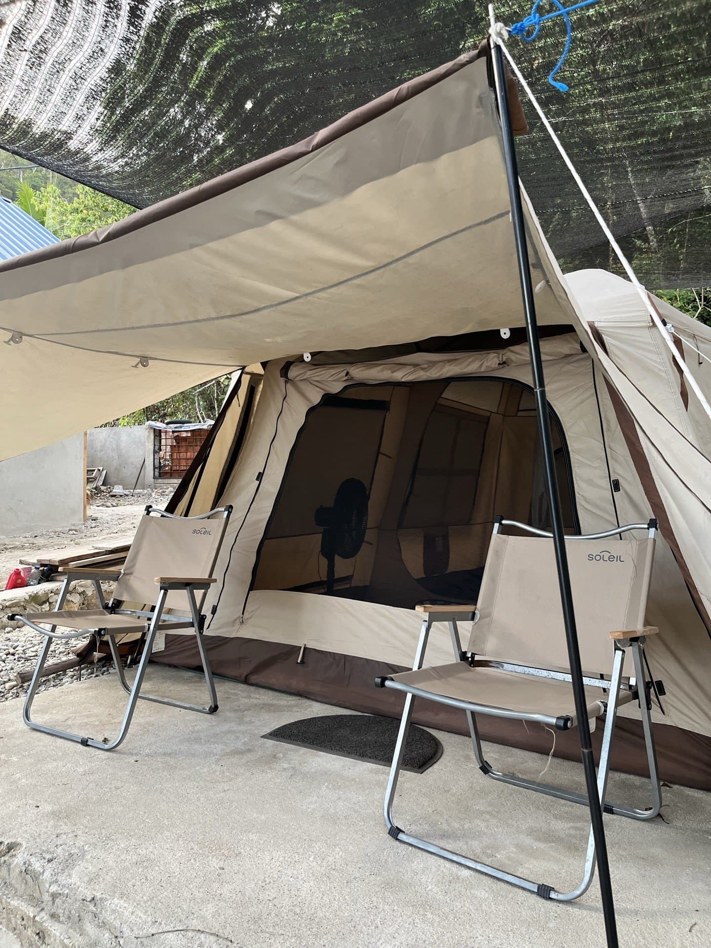 Glamping tent at Shafira Resort with lounge chairs under an awning, by Memit Beach in Morella